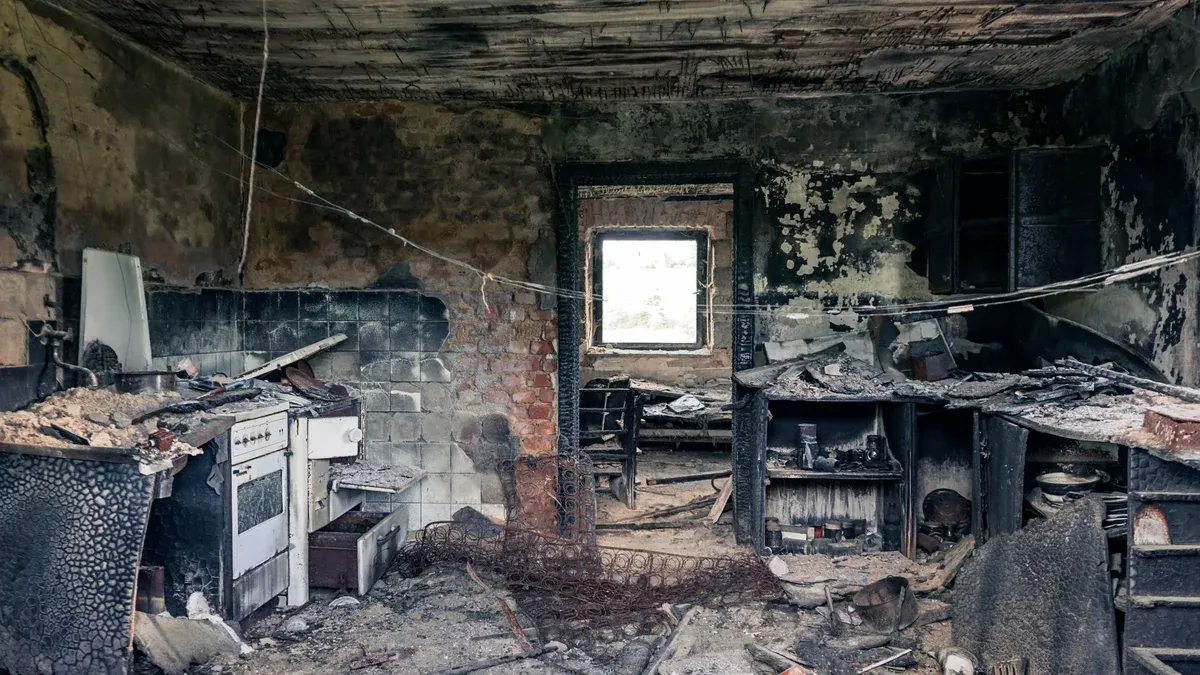 Explore an abandoned, fire-damaged kitchen illustrating decay and destruction.