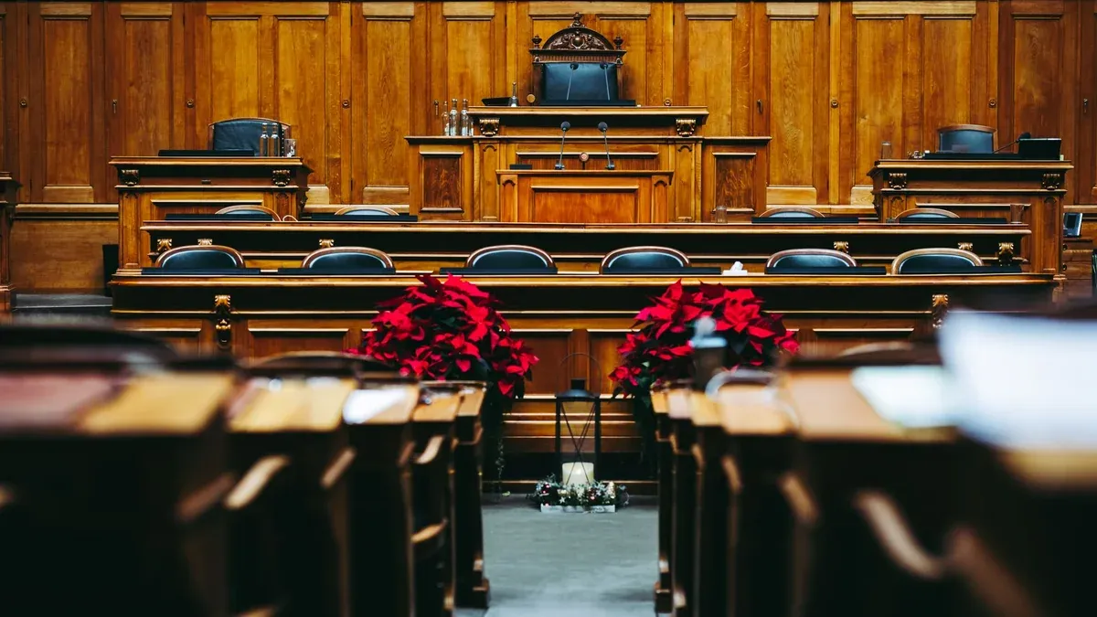 Spacious and elegant wooden courtroom with empty seats, located in Bern, Switzerland.