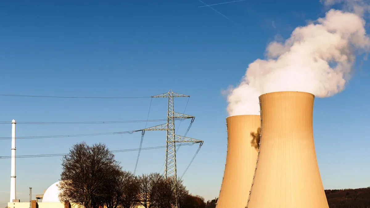 A nuclear power plant in Hameln, Germany, showcasing cooling towers and electricity pylons.