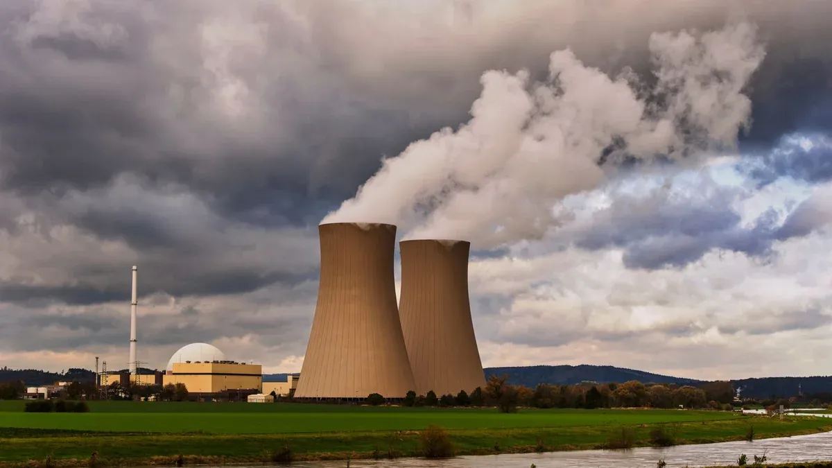 Scenic view of a nuclear power plant with cooling towers emitting steam in Hameln, Germany.