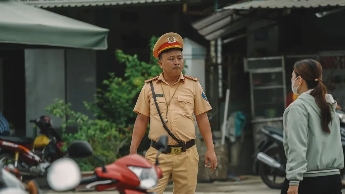 A police officer in uniform directing traffic on a bustling city street.