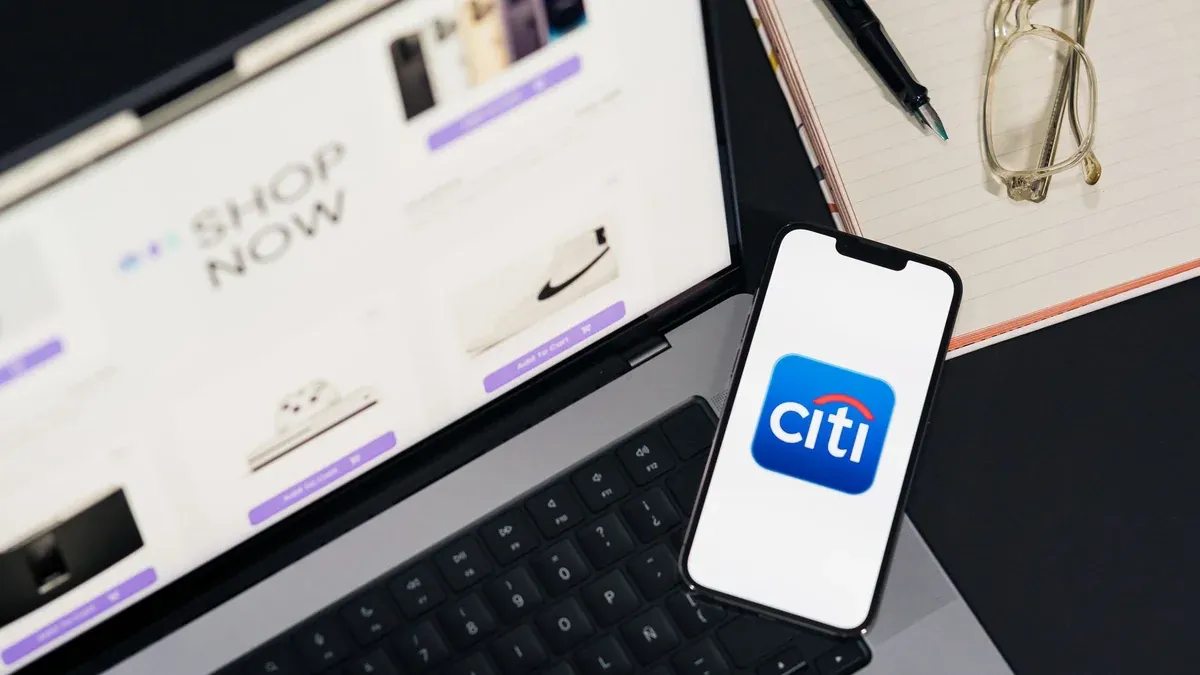 Laptop and smartphone showcasing online shopping and Citi mobile banking app