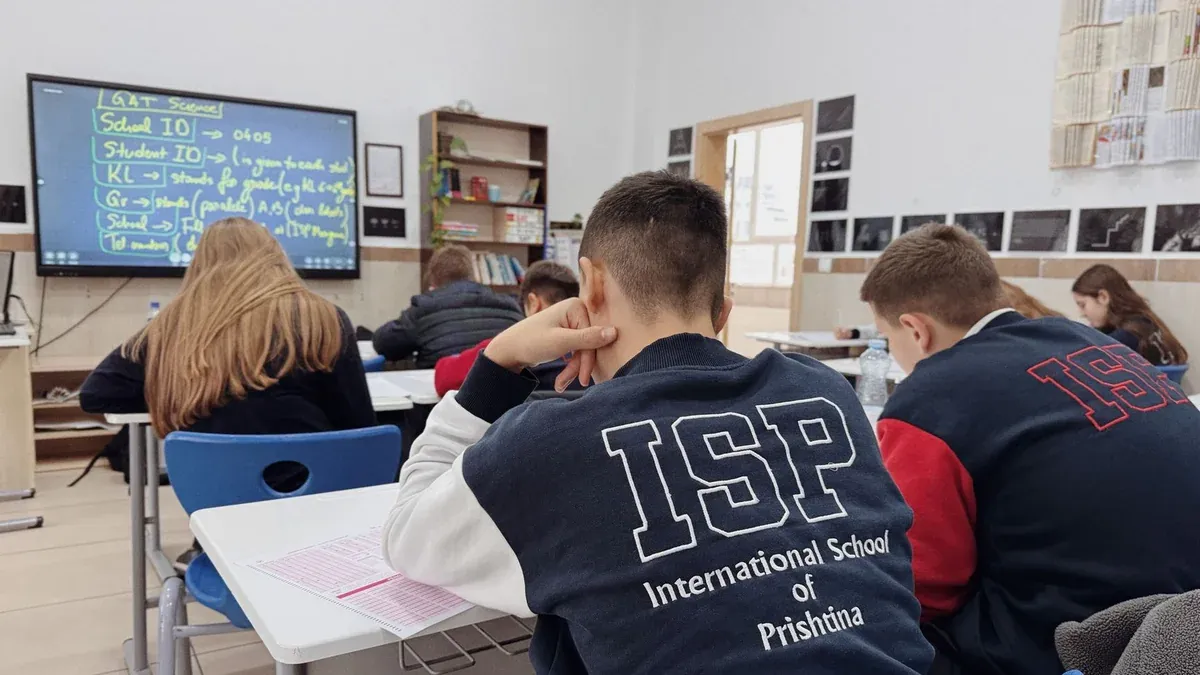 Students attentively learning in a classroom at the International School of Prishtina.