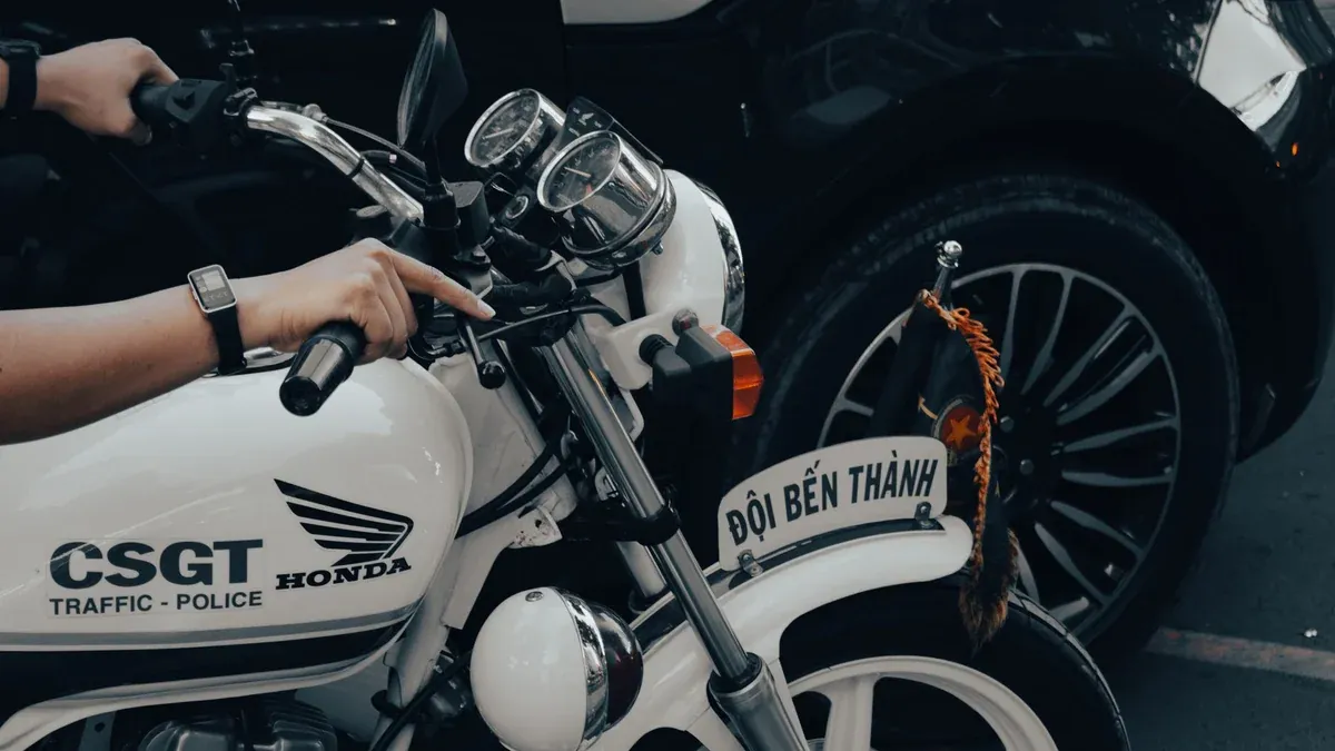 Vietnamese traffic police on a Honda motorcycle in the city streets.