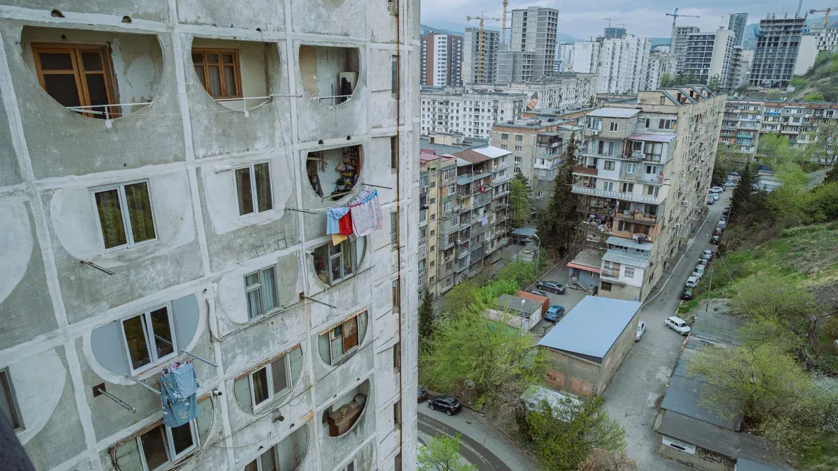 Aerial view of residential apartment buildings and urban landscape in Tbilisi, Georgia.