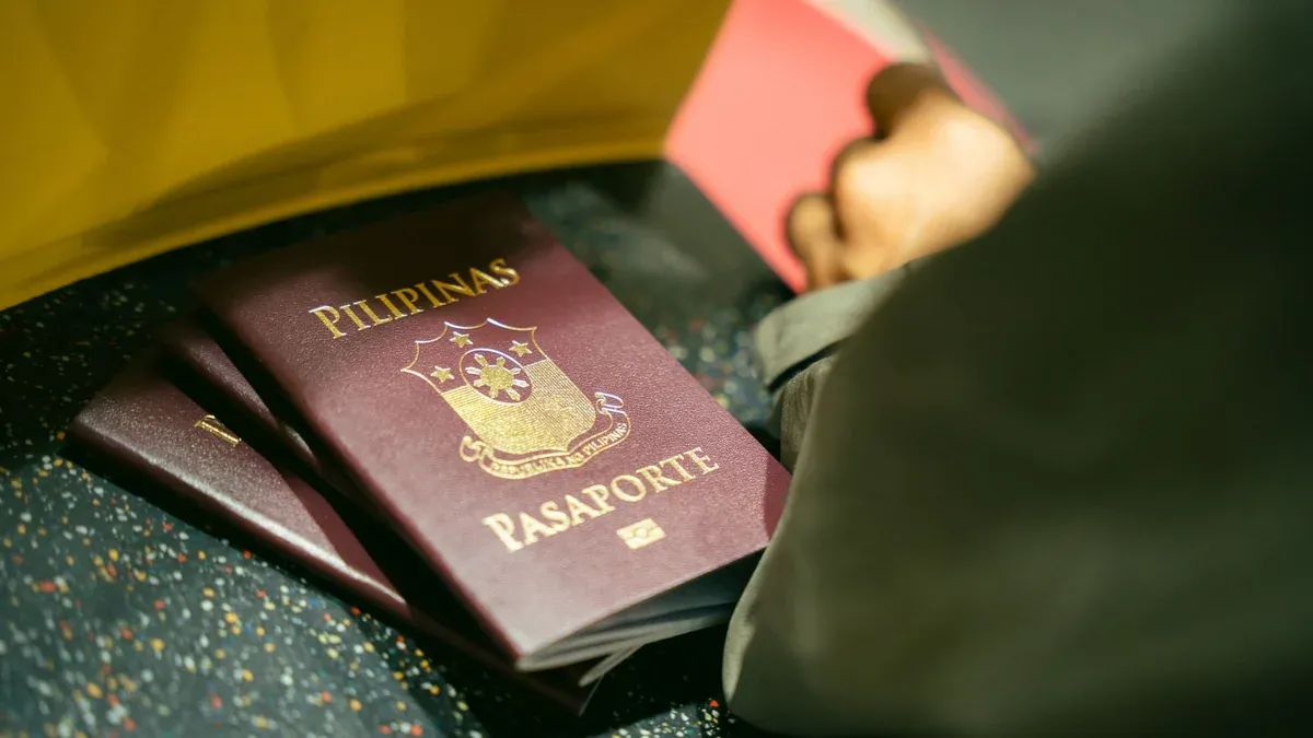 A close-up shot of Filipino passports at the airport, indicating travel and identity.
