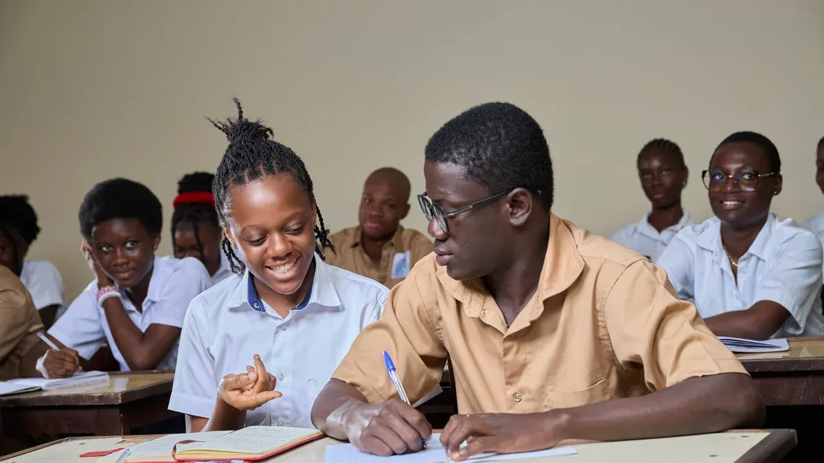 High school students collaborating during a lesson in a classroom environment.