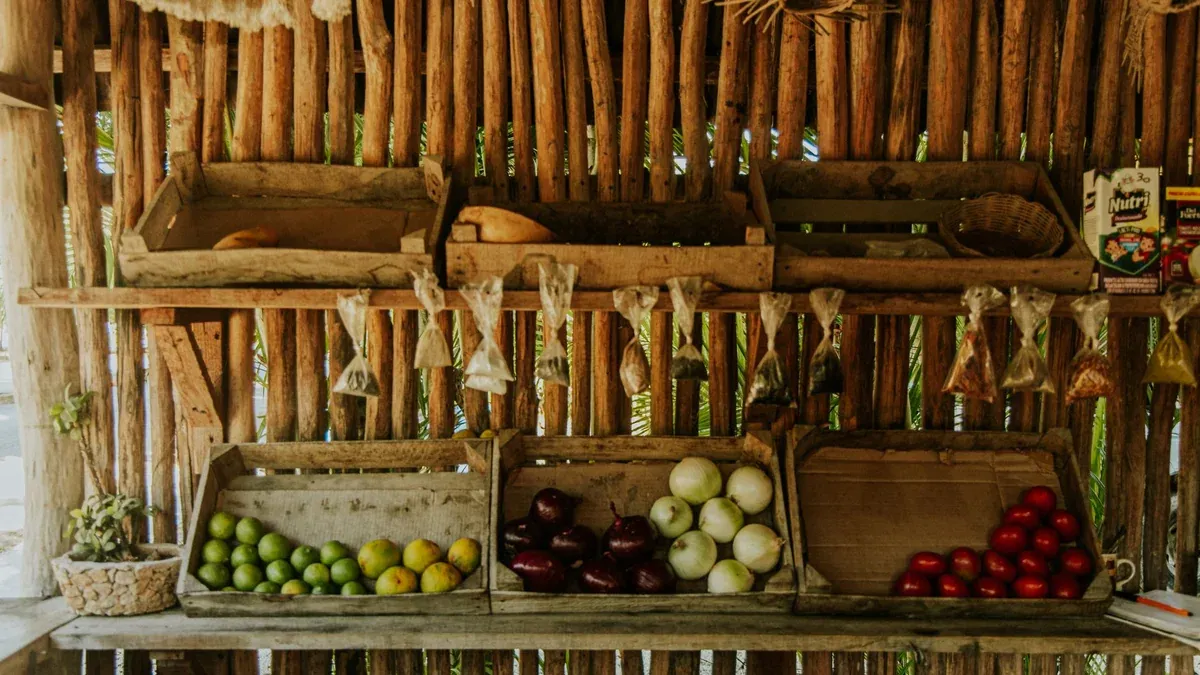 Colorful market stand showcasing local fruits and vegetables in wooden crates.