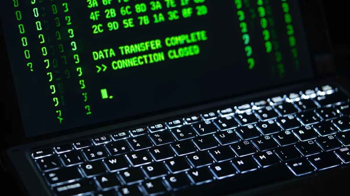 Close-up of a laptop screen displaying green code text. Perfect for cybersecurity themes.