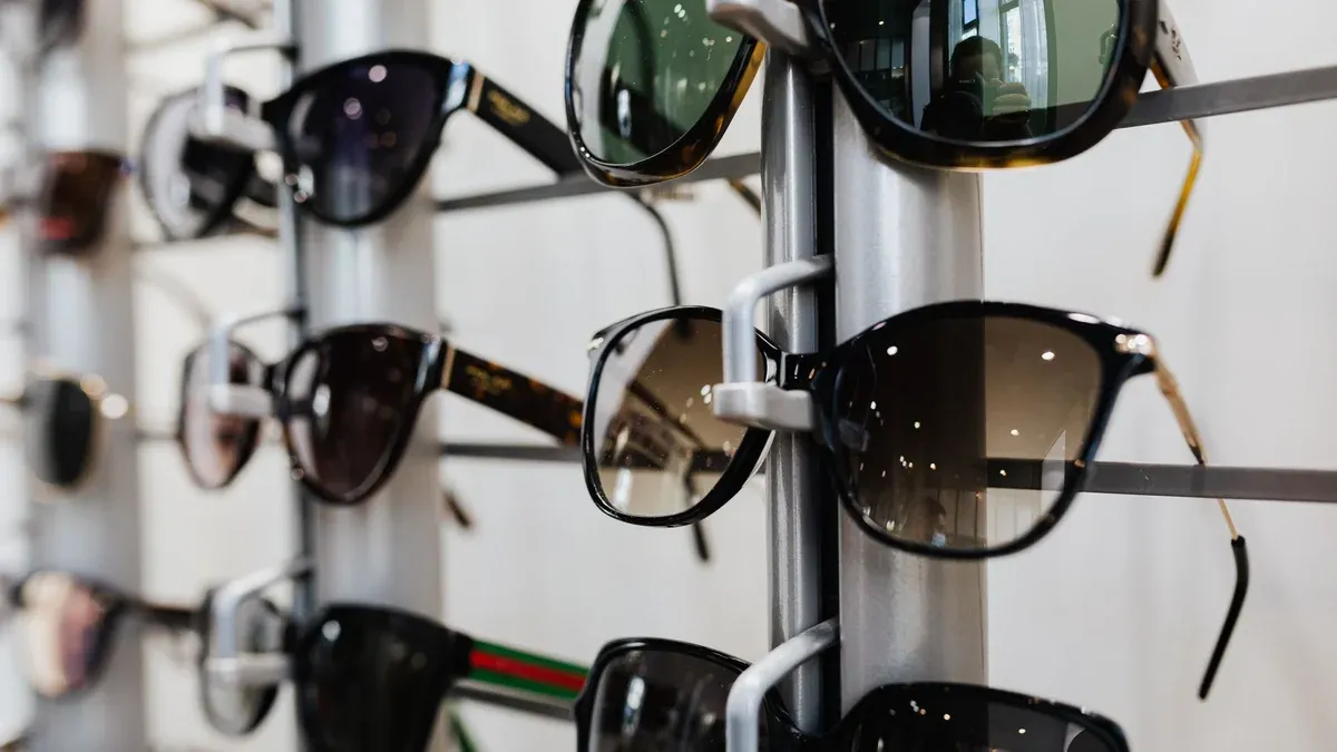 Close-up view of stylish sunglasses displayed on a rack in a retail store.