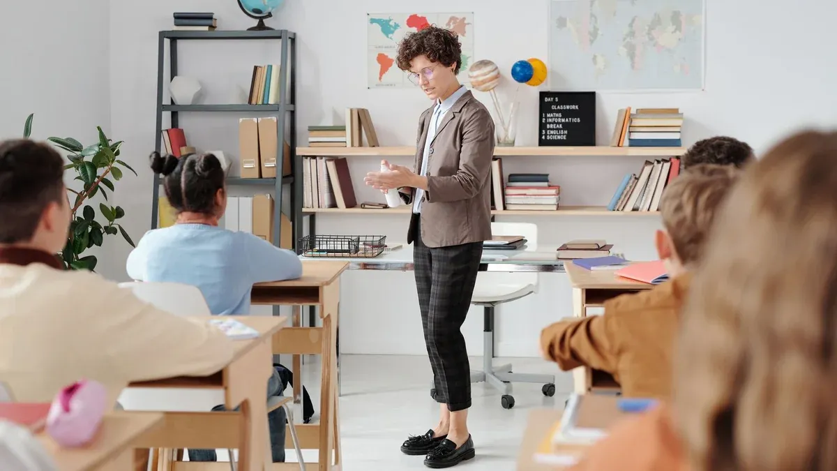 Teacher conducting a classroom lesson with attentive students in a vibrant educational setting.