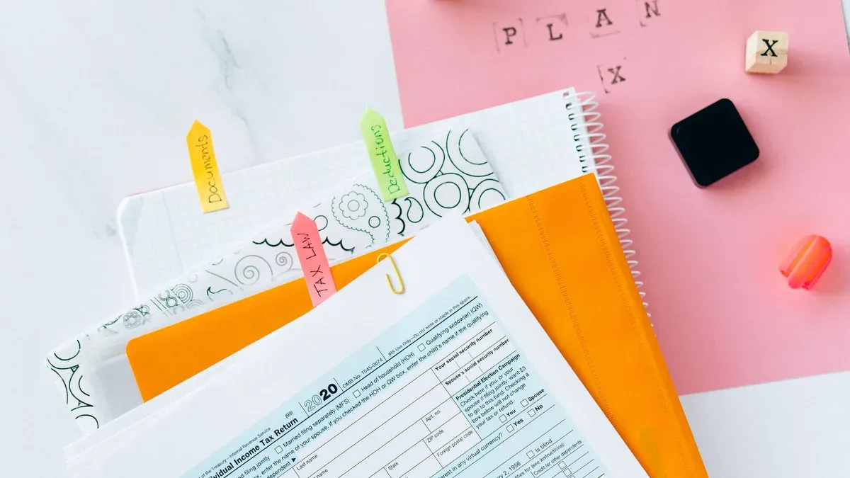 Overhead view of tax documents, forms, and organized work area for tax preparation.