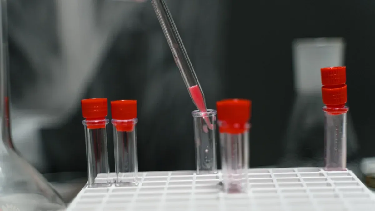 Close-up of pipette transferring liquid in laboratory test tubes.