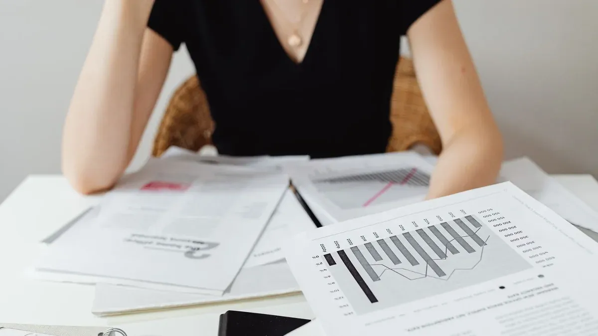 Close-up of financial documents and graphs on a desk, showcasing business analysis.