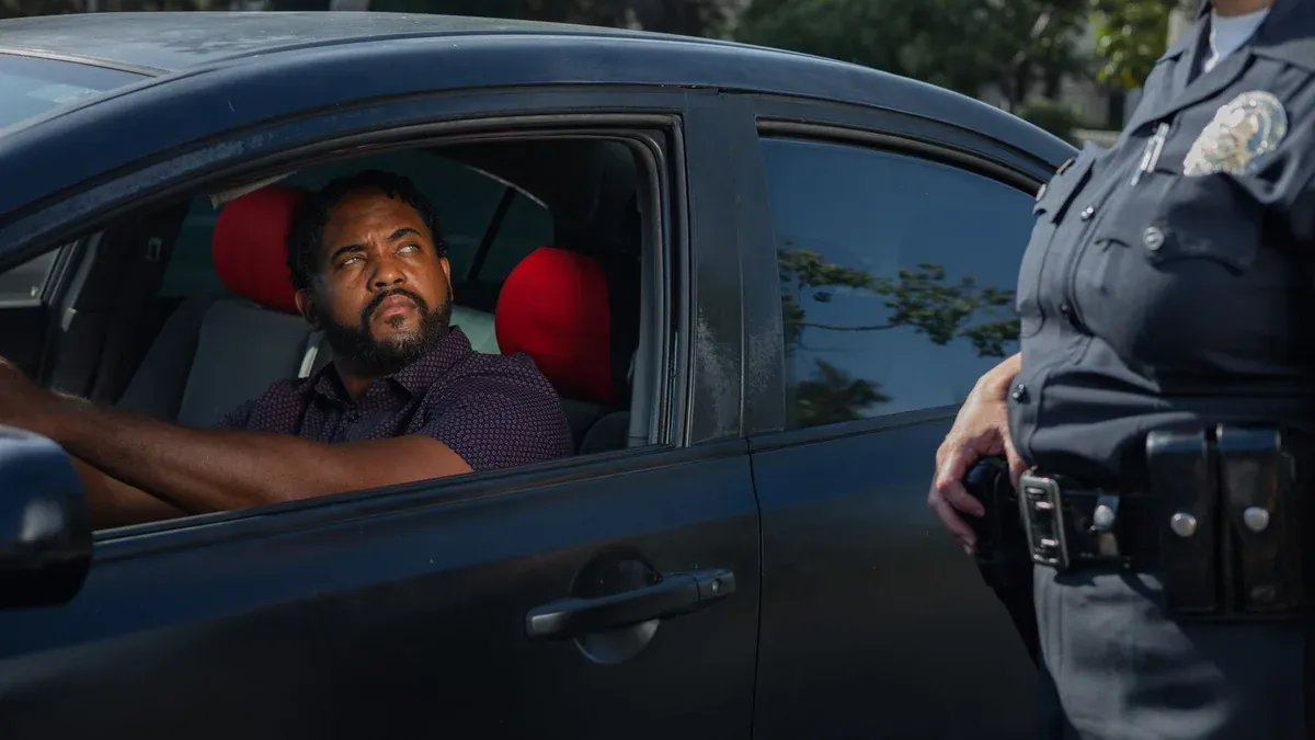 A driver receives a traffic ticket from a police officer for a speeding violation.