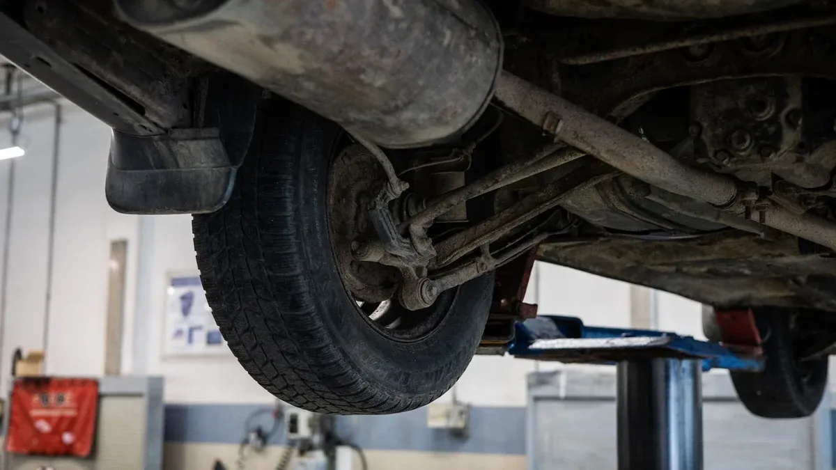 Close-up of car's undercarriage in a service station for repair and maintenance.