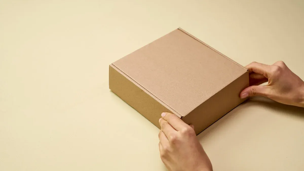 A close-up of hands opening a plain brown cardboard box on a beige surface, perfect for themes of shipping or packaging.